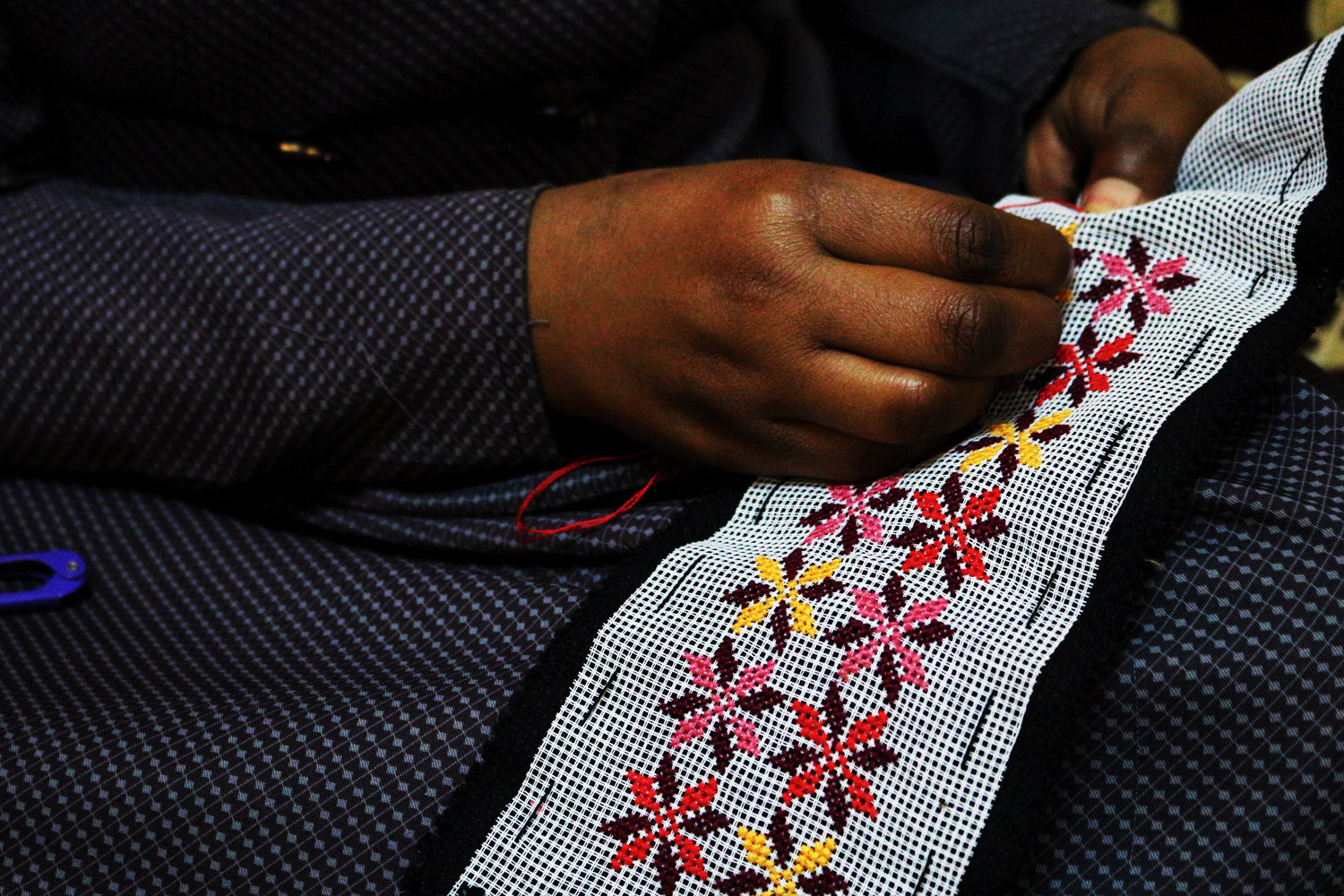 palestinian refugee woman sewing embroidery motif deerah